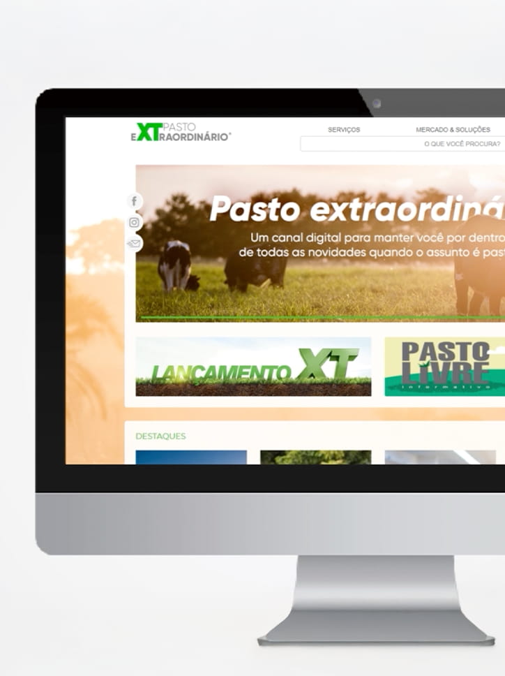 Tela de um monitor exibindo o site "Pasto Extraordinário" da Corteva, com a frase "Um canal digital para manter você por dentro de todas as novidades quando o assunto é pasto".