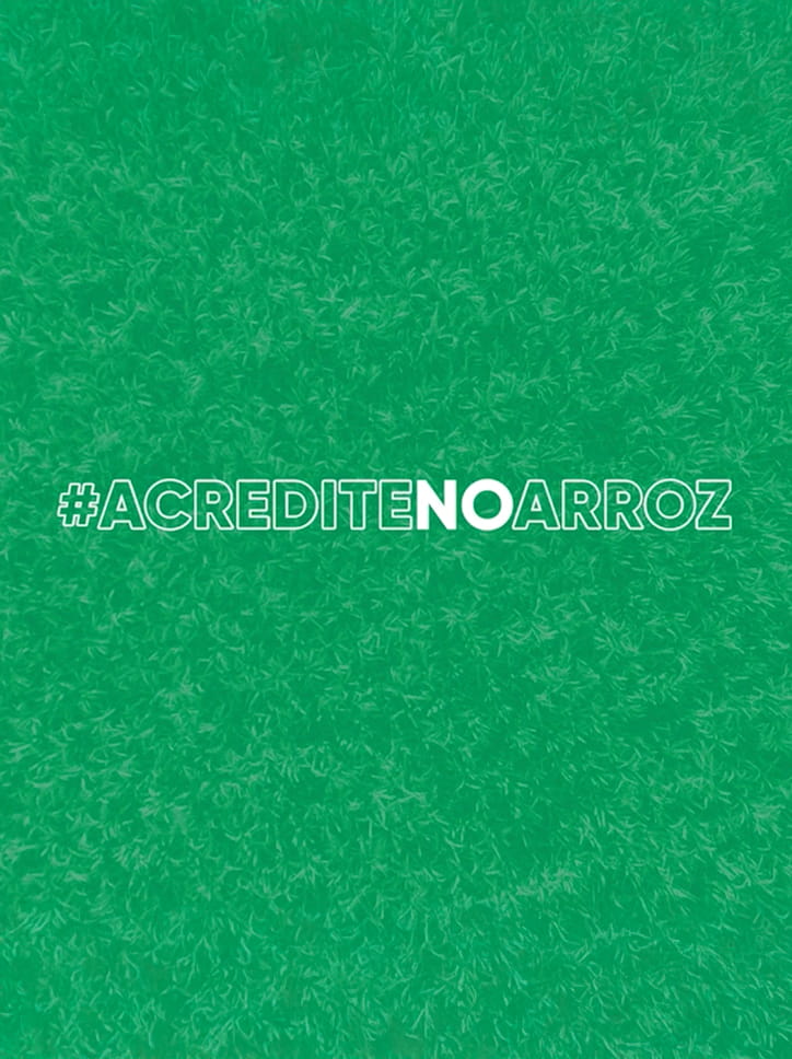 Identidade visual da campanha #AcrediteNoArroz, com a hashtag sobre um fundo verde texturizado.